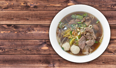 Meat Noodle in a bowl on background. Thai Noodle small line with beef and meat ball. Favorite meal for lunch. Thailand food.