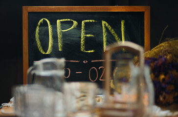 Group of drinking utensil with the opening sign on the chalkboard