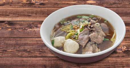 Meat Noodle in a bowl on background. Thai Noodle small line with beef and meat ball. Favorite meal for lunch. Thailand food.