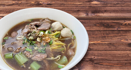 Meat Noodle in a bowl on background. Thai Noodle small line with beef and meat ball. Favorite meal for lunch. Thailand food.