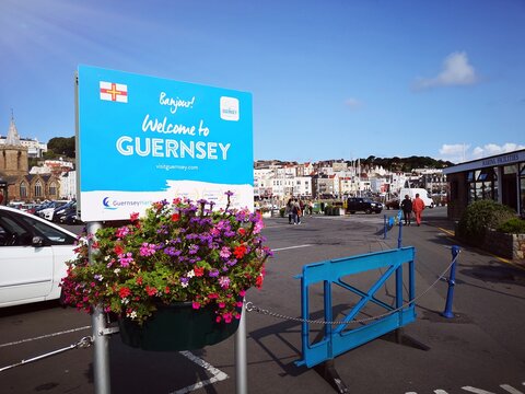 Guernsey, UK: August 25, 2018: Welcome to Guernsey tourism sign at the harbor for visitors to the island. Guernsey is one of the Channel Islands in the English Channel near the French coast.
