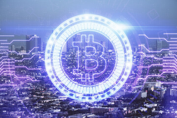 Double exposure of crypto currency theme hologram drawing and city veiw background. Concept of blockchain and bitcoin.