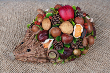 Homemade hedgehog made from straw cones nuts  acorns and canvas