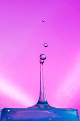 Water Drop Collisions Macro Photography with pink background	