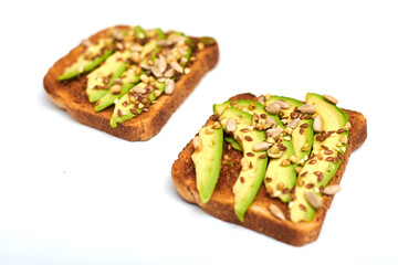 Toast with avocado slices, a mixture of seeds on a white background. Healthy snack tomorrow. The concept of proper nutrition, diet.