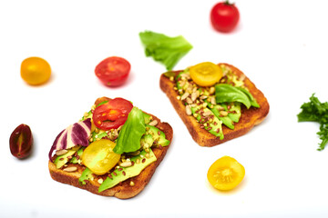 Toasts with vegetables, avocado, tomatoes, a set of seeds on a white background. Healthy food, diet concept.