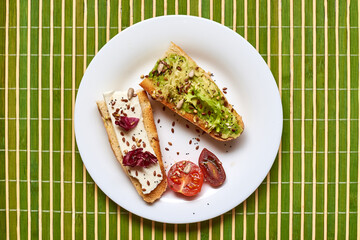 Toasted baguette with avocado and cheese.