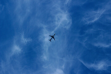 Blurry silhouettevof airplane in the beautiful sky. Travel, transportation concept.