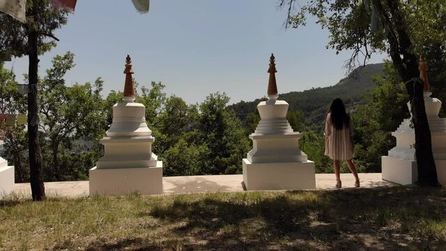 Girl in the Mountains with Stupas and Prayer Flags