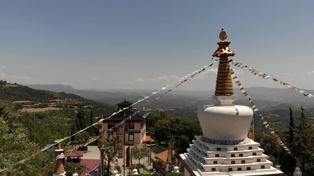 Static View of Top of a Tibetan Chorten of a Buddhist Temple with Prayer Flags Fluttering