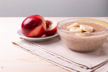 a portion of morning granola porridge served on rustic wooden surface