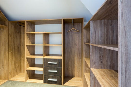 Empty storage room wardrobe cloakroom interior organization with shelving, hanging rails and shoe racks