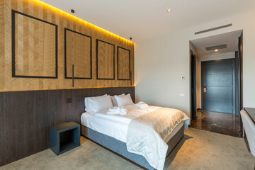 Fototapeta na wymiar Interior of a hotel bedroom with wooden wall