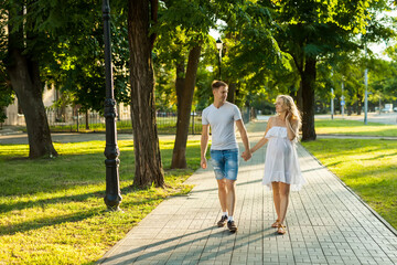 pregnant woman with her husband walking in a park