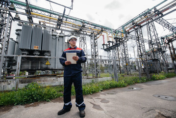 The energy engineer inspects the equipment of the substation. Power engineering. Industry