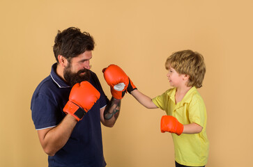 Kid boxing training. Kid in boxing gloves training. Boxing ring. Punching knockout. Childhood...