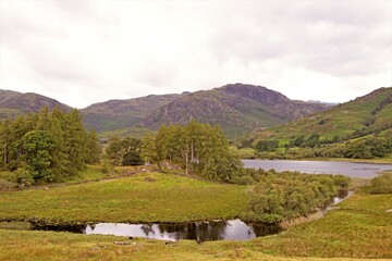 Obraz premium Mountain landscape with lake, at Blea Tarn, Little Langdale, in the Lake District, Cumbria, England.