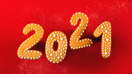 Gingerbread cookies in the shape of the numbers for the new year 2021 balancing on a red background. Anti gravity