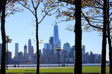 Panorama view of the skyline of Manhattan, New York, from Hoboken, New Jersey - Trees fall season and the new world trade center - Maxwell Place Park