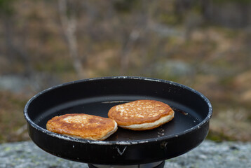 Frying food outdoors with camping kitchen gear, using gas and hiking frying pan