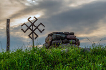 Mystical place in nature. Stone altar, ancient pagan symbols against  of mystic cloudy sky.