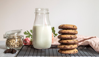Chocolate oatmeal cookies with milk in the morning. Sweet children breakfast concept.