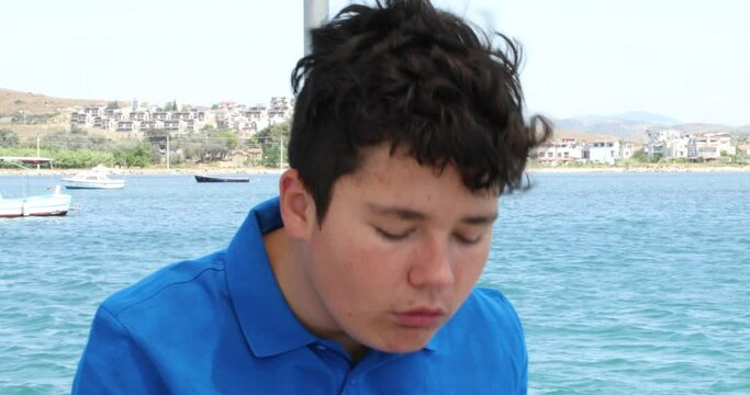 Young boy having a nausea seasickness during the boat trip