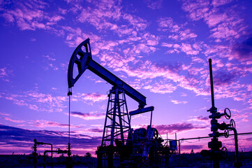 Petroleum concept. Oil pump rig. Oil and gas production. Oilfield site. Pump Jack are running....