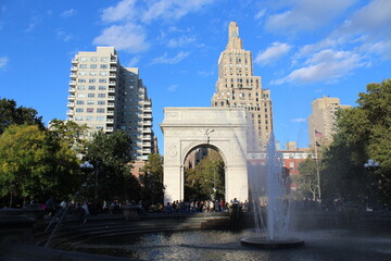 Washington Square Arch  and fountain on a sunny day with blue sky in New York City