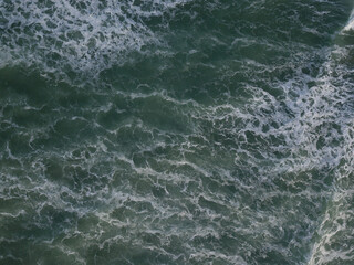 Fototapeta na wymiar Aerial photo of a small surf break off the coast of New Zealand. 