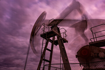 Petroleum concept. Oil pump rig. Oil and gas production. Oilfield site. Pump Jack are running....