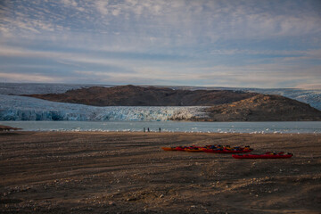 Kayak expedition between icebergs in Narsaq fiords, South West Greenland, Denmark