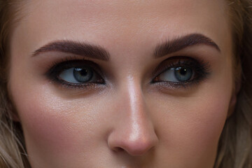 Fototapeta premium Macro shot of woman's beautiful eye with extremely long eyelashes. Sexy view, sensual look. Female eye with long eyelashes