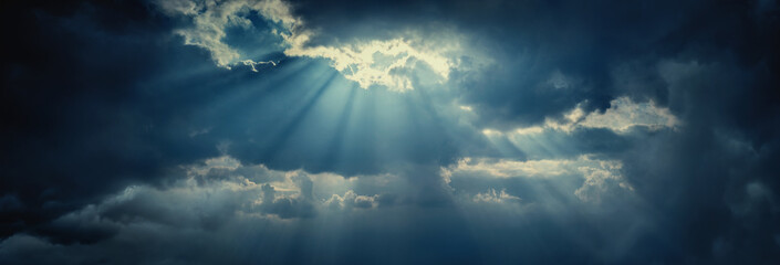 Panoramic view of clouds and sun with beautiful rays against the sky. Dramatic clouds after a...