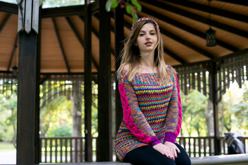 Young beautiful woman posing in the park on the veranda
