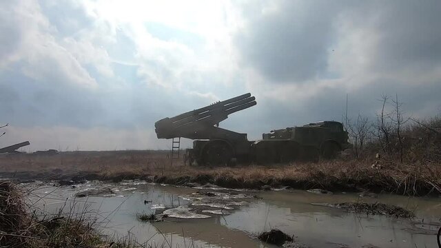 An artillery piece fires a shot