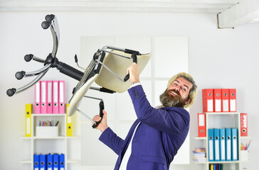Stress concept. Crazy or mad. Furniture sale. Get rid of the excess. Businessman standing in office hold chair. Business man aggressive. Hipster man angry with office chair. Throw out chair