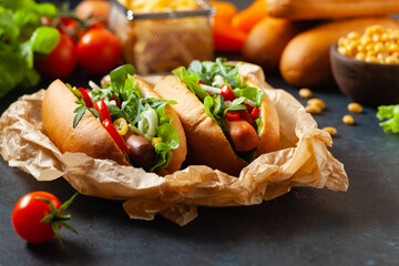Vegetarian hot dogs with soy sausages and fresh vegetables. Front view.