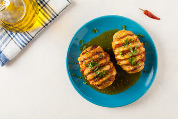 Baked potatoes in Swedish. Hasselback. Stuffed with cheese and bacon. Top view.