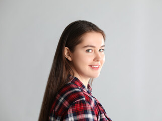 Portrait of young woman on light background