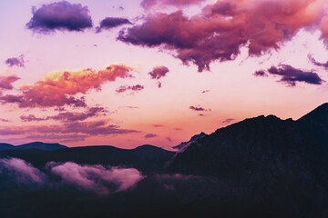 Purple-pink sky with clouds over the silhouette of the Caucasus Mountains
