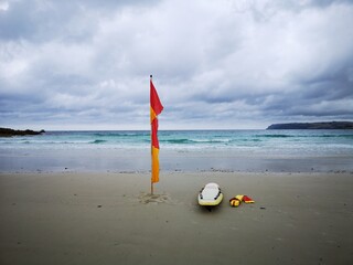 Red and Yellow Flag signifying the safe swim zone on Boat Harbour Beach in north west Tasmania.