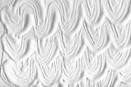 Wavy white paint pattern on wall