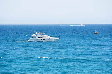 Antalya, Turkey, may 23, 2020. White motor yacht on the waves of the blue a sea