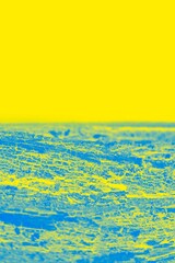 Fototapeta premium Vivid blue yellow background. Half yellow, half patchy blue. Copy space