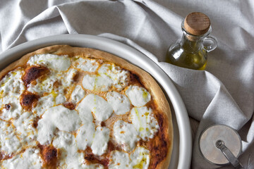 freshly baked pizza in a baking tray