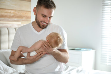 Obraz na płótnie Canvas Father with his newborn son at home