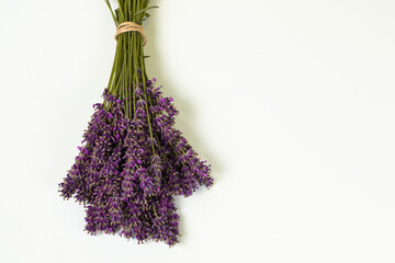 Stack of violet lavender on a white pale background top view