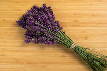Stack of beautiful violet lavender on a wooden background