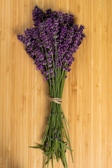 Stack of beautiful violet lavender on a wooden background